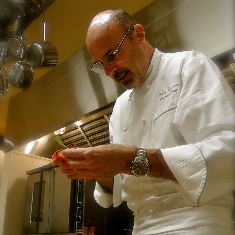 Pascaline's Chef Didier Ageorges preparing a meal.'